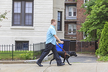 Man with Visual Impairment walking with his service dog