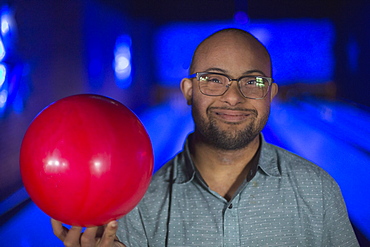 African American man who has Down Syndrome holding a bowling ball