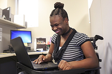 Teen with Cerebral Palsy working in an office