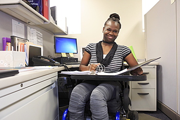 Teen with Cerebral Palsy working in an office