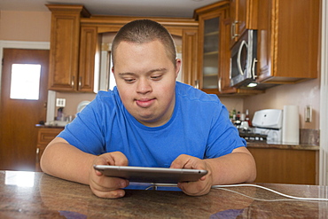 Teen with Down Syndrome using computer