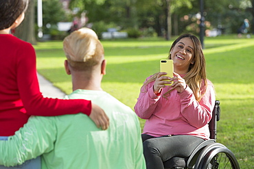 Woman with Spinal Cord Injury taking a picture of her friends