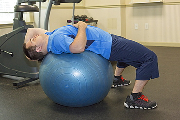 Man with Down Syndrome exercising in a gym