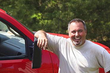 Landscaper smiling next to his truck