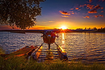 Sunset behind a float plane at Lake Hood Seaplane Base, South-central Alaska in summertime; Anchorage, Alaska, United States of America