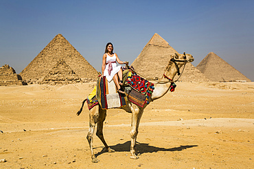 Female tourist on a camel, Giza Pyramid Complex, UNESCO World Heritage Site; Giza, Egypt