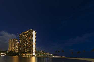 Condominiums along the coastline of Waikiki at sunrise; Honolulu, Oahu, Hawaii, United States of America