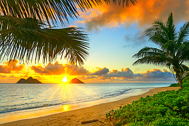 Sunrise viewed from Lanikai Beach with a view of the Mokulua Islands off the coast; Oahu, Hawaii, United States of America