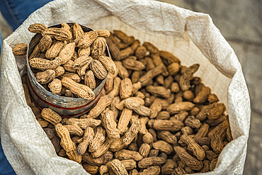 Peanuts for sale in a sack with a metal scoop; San Cristobal de las Casas, Chiapas, Mexico