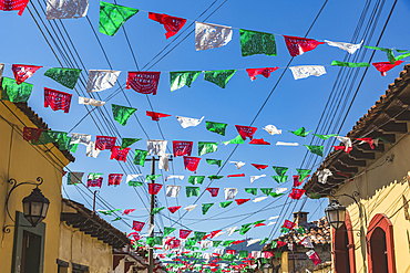 Garlands strung across a street between buildings; San Cristobal de las Casas, Chiapas, Mexico