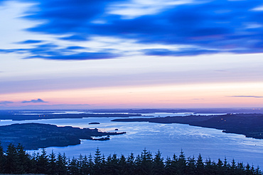 Dawn over Lough Derg with trees in the foreground, long exposure; County Clare, Ireland