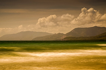 Long exposure of an Australian beach with mountain backdrop, Four Mile Beach; Port Douglas, Queensland, Australia