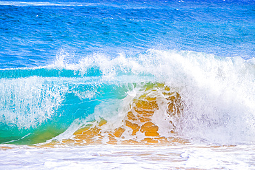 Splashing waves along the shore of sand; Oahu, Hawaii, United States of America