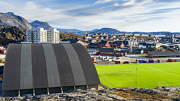 A sports field and structure with a view of a neighbourhood and mountains; Nuuk, Sermersooq, Greenland