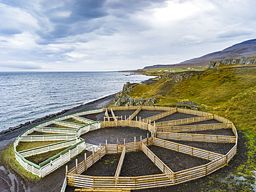 A circular farming structure a animal enclosures along the coast; Hunaping vestra, Northwestern Region, Iceland