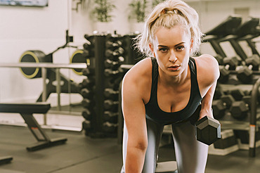 Woman working out with weights; Wellington, New Zealand