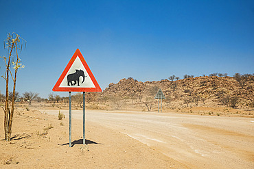 Elephants warning sign on a roadside, on the road to Brandberg Mountain, Damaraland; Kunene Region, Namibia