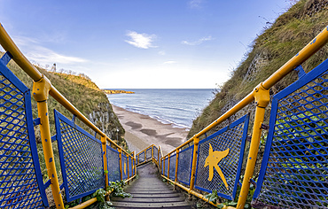 Steps with colourful railing leading down to the beach, Marsden Bay; South Shields, Tyne and Wear, England