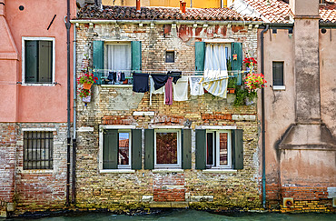 Clothesline and a residential building along a canal; Venice, Italy