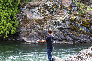 A man fly fishing on Adams River, near Salmon Arm; British Columbia, Canada