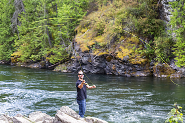 A man fly fishing on Adams River, near Salmon Arm; British Columbia, Canada