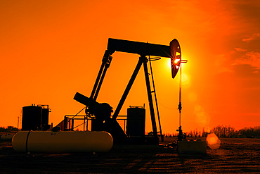 Pumpjack at sunset; Alberta, Canada