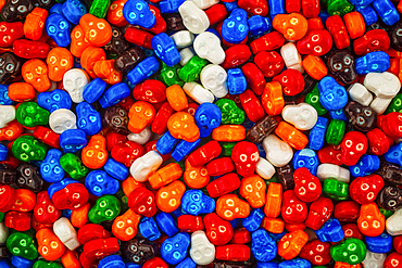 Colourful pile of skull candies in red, blue, orange, green, white, orange and brown; Studio