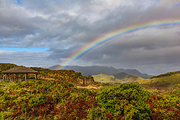 Rainbow crossing the mountainous landscape on the island of Terceira; Terceira, Azores, Portugal