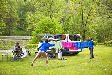 A group plays badminton at their campsite just outside of the town centre of the little medieval city of Cesky Krumlov in the South Bohemian region of Czech Republic; Cesky Krumlov, Bomenia, Czech Republic