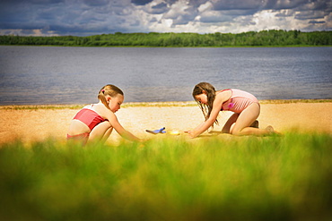 Two Girls Playing On The Beach