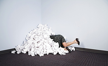 Businesswoman Buried In Pile Of Paper