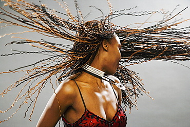 Young Woman Twisting Head And Swinging Corn Braids