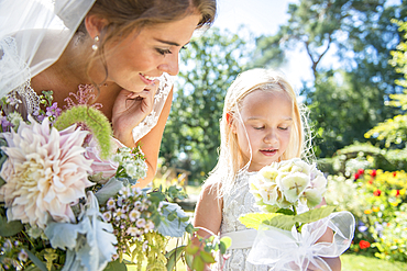 A bride with her young bridesmaid on her wedding day