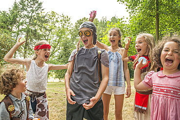 Young children play games outside in the sunshine