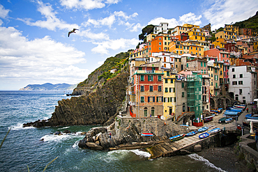 Riomaggiore perched on an outcrop above the sea, Cinque Terre along the coastline of Italy, Riomaggiore, La Spezia, Italy