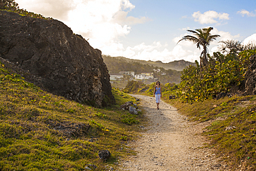 Scenic view of a woman walking on a seaside path at Bathsheba, Bathsheba, Barbados, Caribbean