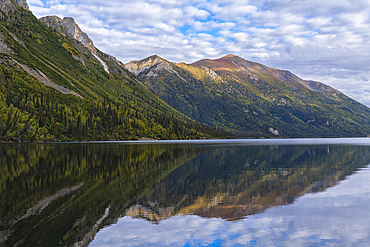 Beautiful reflections of the mountains in Tincup Lake, near Burwash Landing, Yukon, Canada