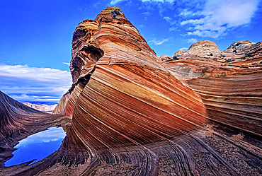 Spectacular formation of vibrant colors in swirls of fragile sandstone is known as The Wave and is located in the Coyote Buttes section of Vermilion Cliffs National Monument. An unmarked wilderness trail limits hikers and requires a permit from the Bureau of Land Management, Arizona, United States of America