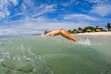 Teenager dives into the Caribbean surf, Country of Aruba