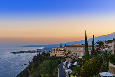 View of Taormina, Sicily, Italy and the coastline at sunset, Taormina, Sicily, Italy