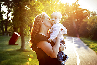 Mother spending quality time with her son who has Down Syndrome in a city park during an bright sunny autumn day, Leduc, Alberta, Canada