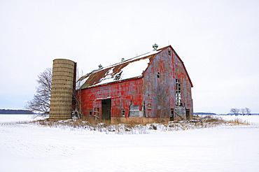 Abandoned red barn in rural Ontario, seen here in the winter, Strathroy, Ontario, Canada