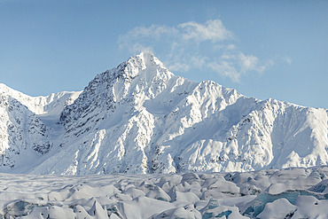 Snow-covered mountain peaks on a bright sunny day near Knik Glacier, Alaska, United States of America