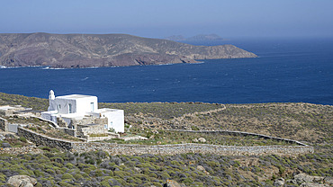 Whitewash building with stone walls along the coast of the island of Mykonos, Greece, Ano Mera, South Aegean, Greece