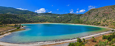 Panoramic view of the turquoise-green waters of Venere's Mirror a thermal lake formed in an extinct volcanic crater on Pantelleria Island, Sicily, Italy