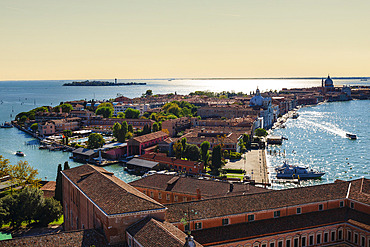 View of a canal and lagoon at sunset from the bell tower of the church of San Giorgio Maggiore, Venice, Italy