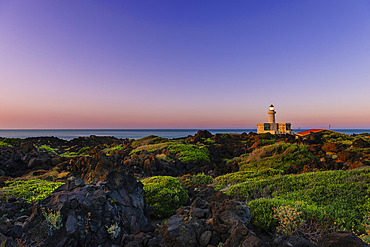 Scenic view of the coastal landscape with the Lighthouse at Faro Di Punta Spadillo in the National Park of Pantelleria Island at twilight, Pantelleria Island, Trapani, Sicily, Italy