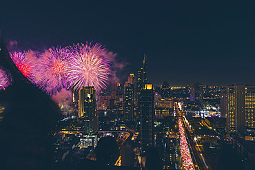 Fireworks light up the night sky over downtown Bangkok on New Years Eve, Bangkok, Thailand