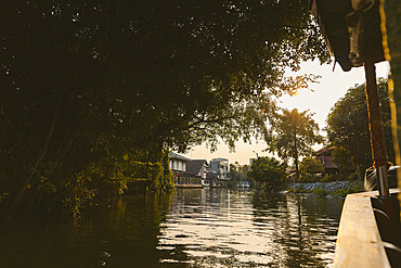 View of the tranquil canal at twilight during a canal boat tour in the 'Bangkok Noi' area, Bangkok, Bangkok, Thailand