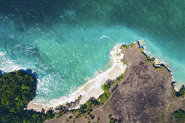 Aerial view of Mbawana Beach, with surf and turquoise ocean water rolling into the white sand beach below, East Nusa Tenggara, Indonesia, Kodi Bangedo, Southwest Sumba Regency, East Nusa Tenggara, Indonesia